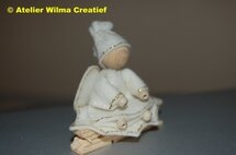 Pakket Witte engel zittend op een hulsblad